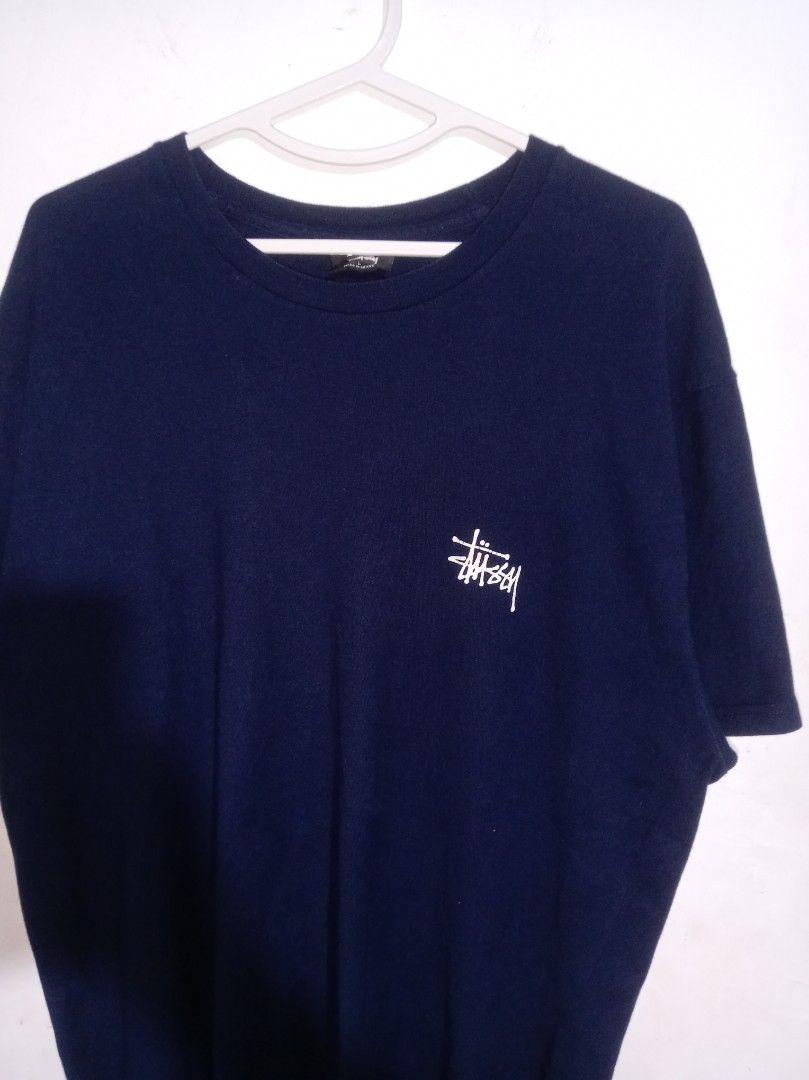 Stussy Navy Blue Logo Tee Size L (Category: Tshirts & Polo Shirts ) located in Nagcarlan. Submitted by asd0606 (Listing ID 1469503467, Image 3). Description: - Brand: Stussy - Color: Dark Navy Blue - Size: Large (tag inside collar) - Origin: Made in Mexico - Design: Small left-chest print with a large back graphic - Fit: Standard crew neck, short sleeves - Condition: Clean cotton fabric, solid everyday streetwear staple 799+sf Authenticity not gu