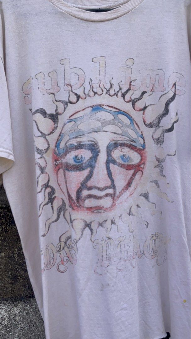 Sublime Sun Face Band T-Shirt Size S (Category: Tshirts & Polo Shirts ) located in Balanga. Submitted by death_vintage (Listing ID 1469476332, Image 2). Description: - Brand: Sublime - Design: Classic sun face graphic - Color: Cream white (faded vintage look) - Size: Small - Material: 100% cotton - Condition: Clean and well-maintained - Features: Short sleeves, crew neck, made in Nicaragua.