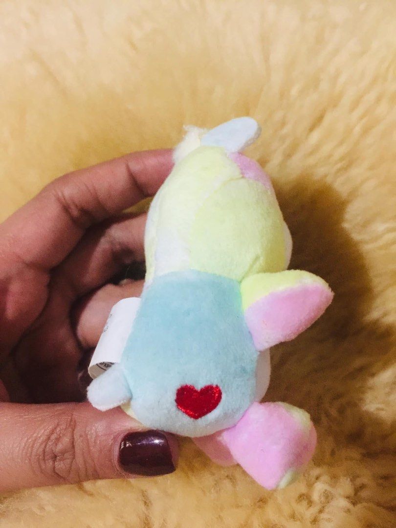 Super Impulse Care Bears Care Bears Togetherness Bear (Category: Plushies & Soft Toys) located in Baguio. Submitted by izza_thrifty (Listing ID 1469567597, Image 3). Description: - Authentic Mini Togetherness Bear plush toy with original tag (2023) - Pastel tie-dye multicolored fur with star and rainbow belly badge - Sweet pink embroidered heart on the foot and red heart on the back - Tiny, portable size that fits right in the palm of your hand -