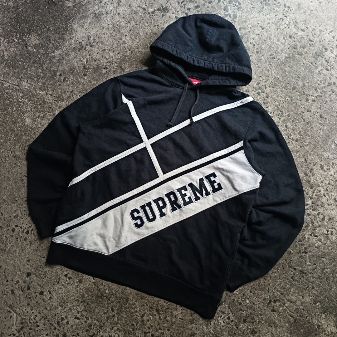 Supreme Diagonal Stripe Hooded Sweatshirt Black Large (Category: Hoodies) located in Caloocan City. Submitted by gemfinder669 (Listing ID 1469524829, Image 1). Description: Black Authentic Supreme hoodie with white diagonal contrast stripes and bold stitched logo across the front. Drawstring hood, ribbed cuffs, and hem. Size Large tag attached inside. Interior care label lists 100 percent cotton, machine wash cold, made in China. Fabric shows sli