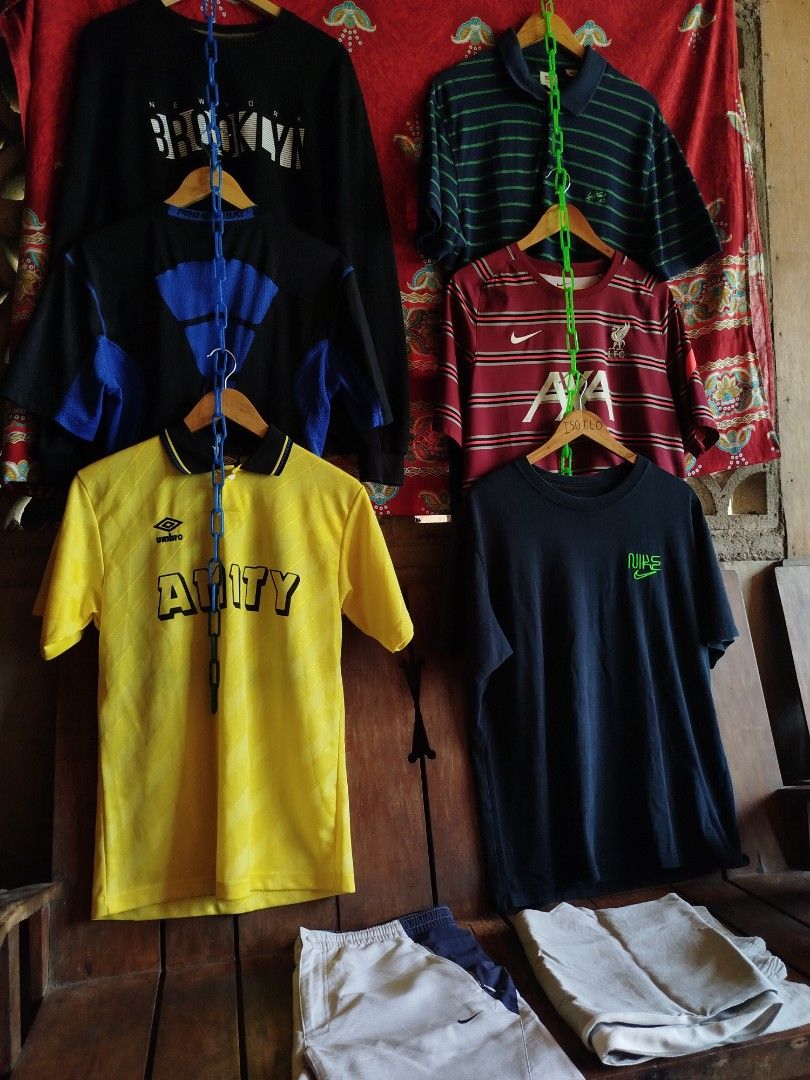 Take All Aspack for only 1300 (Category: Tshirts & Polo Shirts ) located in Tubigon. Submitted by 4dos_thrift (Listing ID 1469418130, Image 1). Description: - Bundle deal: Sports jerseys, casual tees, and shorts available - Includes: Yellow Umbro football shirt, black and blue graphic top, maroon Liverpool Nike jersey, black Nike tee with green logo, striped polo, and black Brooklyn long sleeve - Bottoms: Shorts included at the bottom of the bund