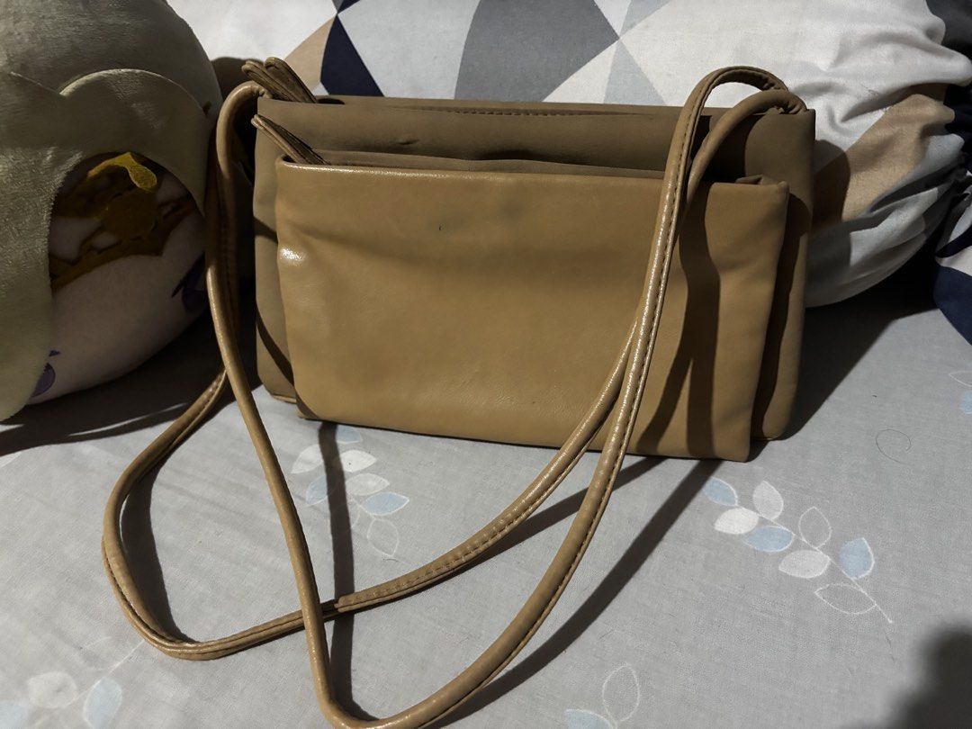 Tan brown multi-compartment shoulder crossbody bag (Category: Cross-body Bags) located in Manila. Submitted by cleverdog_2c1729 (Listing ID 1469513641, Image 1). Description: - Color: Versatile tan brown that matches any outfit - Storage: Multiple zipped compartments to keep your essentials organized - Strap: Slim, comfortable shoulder strap for easy wear - Capacity: Ideal everyday size for phone, keys, and wallet - Condition: Brand new and ready