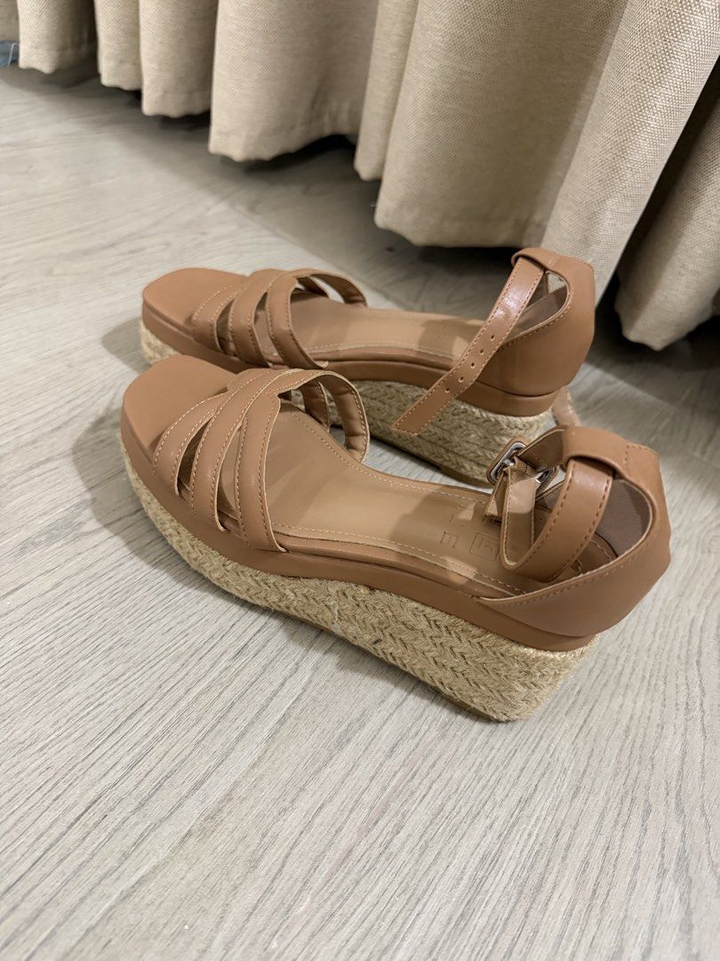 Tan espadrille platform wedge sandals ankle strap (Category: Wedges) located in Manila. Submitted by chanelmari19 (Listing ID 1469525876, Image 1). Description: - Style: Tan platform wedge sandals with braided jute heel wrap - Design: Multiple thin straps across the top of the foot with soft tan insoles - Closure: Adjustable ankle strap with buckle for a secure fit - Comfort: Very comfortable height designed for all-day wear - Versatility: Neutra