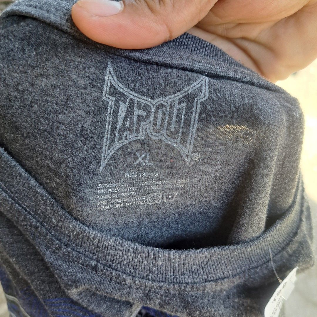 Tapout Graphic Tee Dark Grey Blue Size XL (Category: Tshirts & Polo Shirts ) located in Manila. Submitted by warmphoenix_5fc5b2 (Listing ID 1469540578, Image 2). Description: - Brand: Tapout - Color: Dark Grey - Size: XL - Design: Large blue graphic print with fist, snakes, and 'Driven to Win' text - Material: Soft cotton blend - Style: Short sleeves, crew neck - Shipping or meetups available across the Philippines.