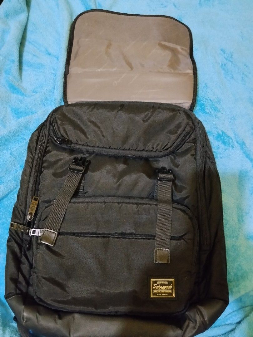 Technopack Black Backpack with Multiple Pockets and Buckles (Category: Backpacks) located in Manila. Submitted by rjzon (Listing ID 1469511462, Image 3). Description: Original Technopack backpack - Bought from SM for 2.1k pesos. Can give for 900-1.1k negotiable - Brand/Model: Technopack Black Backpack - Storage: Front zipper pockets, dual buckle straps over the flap, and multiple side and back compartments - Comfort: Equipped with padded shoulder