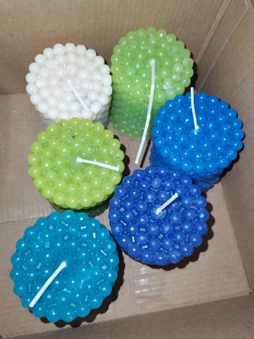 Textured Bubble Pillar Candles Assorted Colors (Category: Home Fragrance) located in Manila. Submitted by geminibibo (Listing ID 1469420601, Image 1). Description: Handmade bubble candles in white, light green, bright green, light blue, and dark blue. Perfect for home decor and room styling. Each pillar-shaped candle features a textured sphere surface and a white cotton wick, safely packed in a cardboard box..