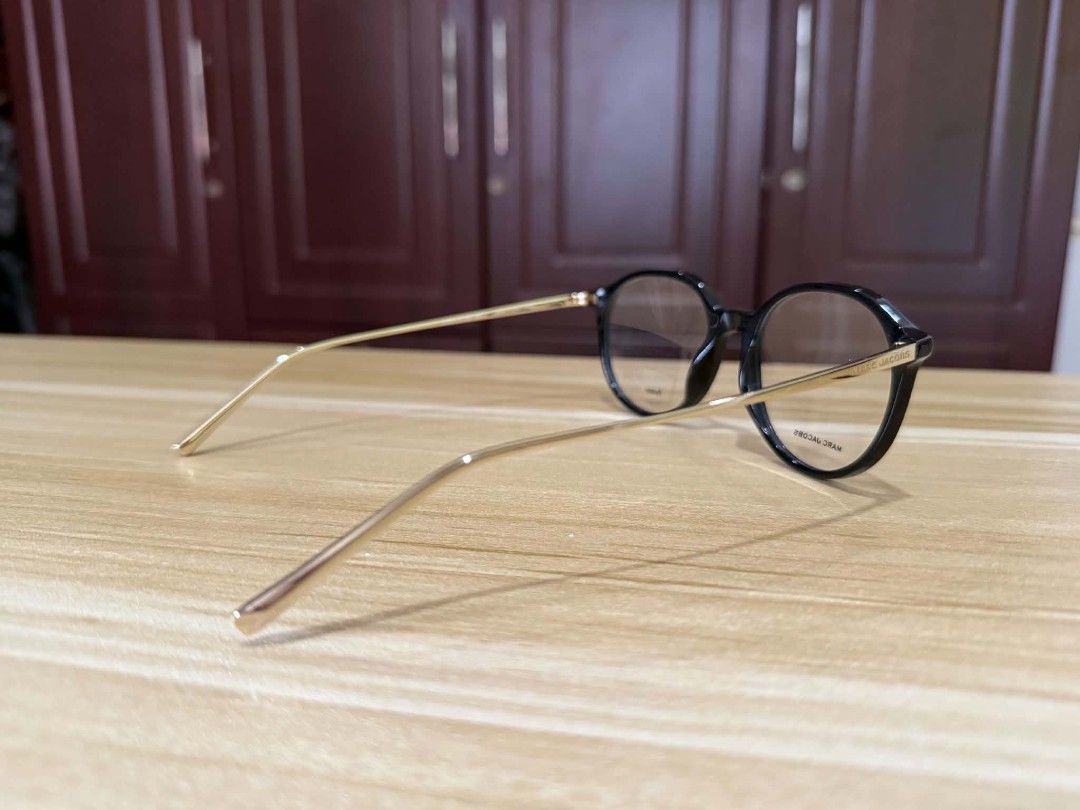 The Marc Jacobs Black Round Acetate Eyeglasses with Case (Category: Sunglasses & Eyewear) located in Bacoor. Submitted by sepiyow (Listing ID 1469567960, Image 3). Description: - Brand: The Marc Jacobs - Style: Round frame glasses in a chic black and gold tone - Material: Premium acetate front with slim gold-finish temples - Lenses: Fitted with demo lenses (ready for your own prescription or non-prescription wear) - Inclusion: Original black hard
