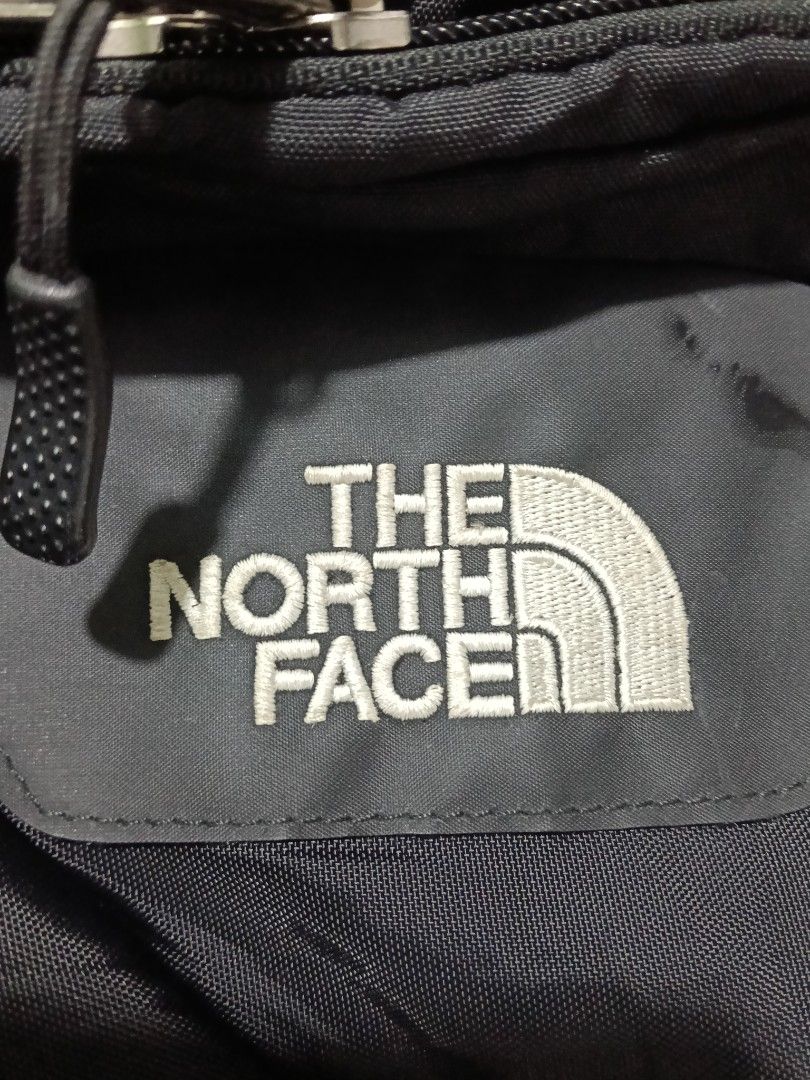 The North Face Hot Shot Backpack Black (Category: Backpacks) located in Manila. Submitted by marvinenri31598 (Listing ID 1469567263, Image 3). Description: - Brand: The North Face - Model: Hot Shot Backpack - Color: Solid Black - Material: Durable nylon and polyester build - Storage: Multiple zip compartments and mesh side pockets - Comfort: Adjustable straps with padded mesh backing - Details: Front daisy chain loops, embroidered logo, and brand