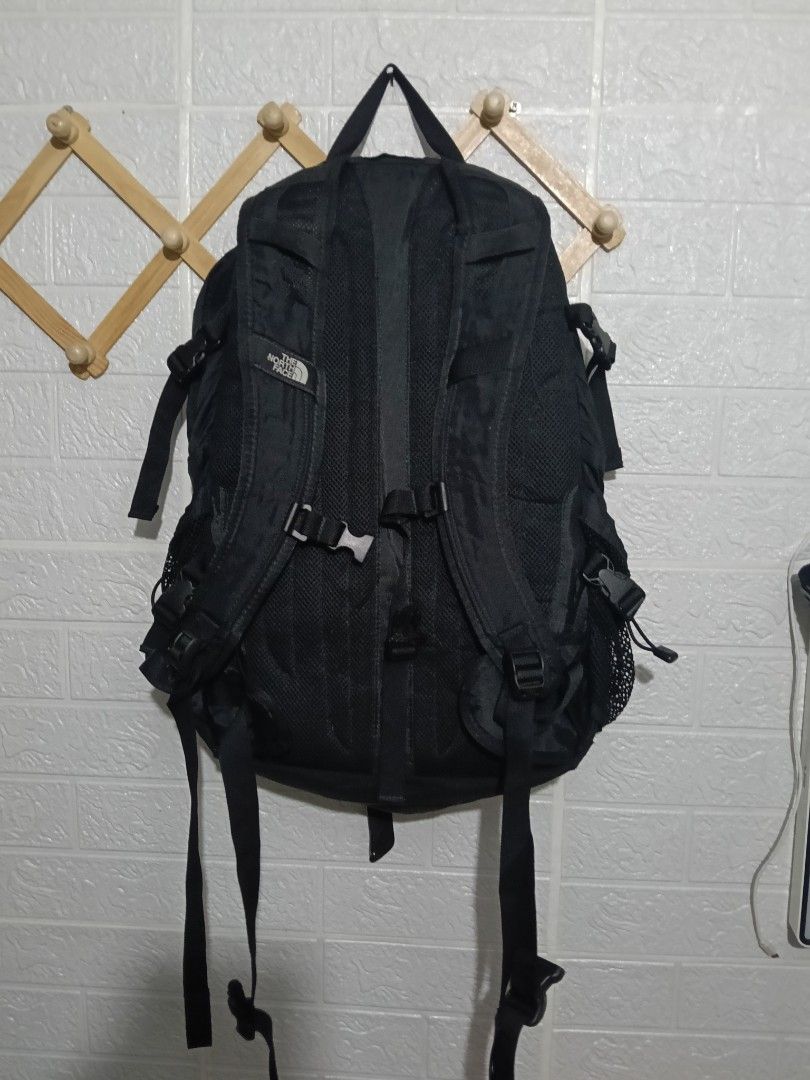 The North Face Hot Shot Backpack Black (Category: Backpacks) located in Manila. Submitted by marvinenri31598 (Listing ID 1469567263, Image 2). Description: - Brand: The North Face - Model: Hot Shot Backpack - Color: Solid Black - Material: Durable nylon and polyester build - Storage: Multiple zip compartments and mesh side pockets - Comfort: Adjustable straps with padded mesh backing - Details: Front daisy chain loops, embroidered logo, and brand