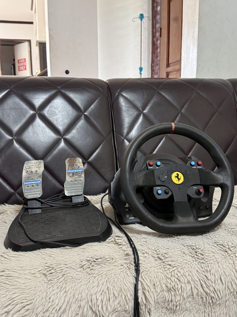 Thrustmaster T300 Ferrari for PlayStation / PC (Category: Controllers) located in Manila. Submitted by adrian.unisa (Listing ID 1469458924, Image 1). Description: - Thrustmaster T300 Ferrari - Includes foot pedal unit with textured base and metal plates (shows visible rust spots) - PS4 / 5 and PC compatible T2PA Pedals With box Cavite area.