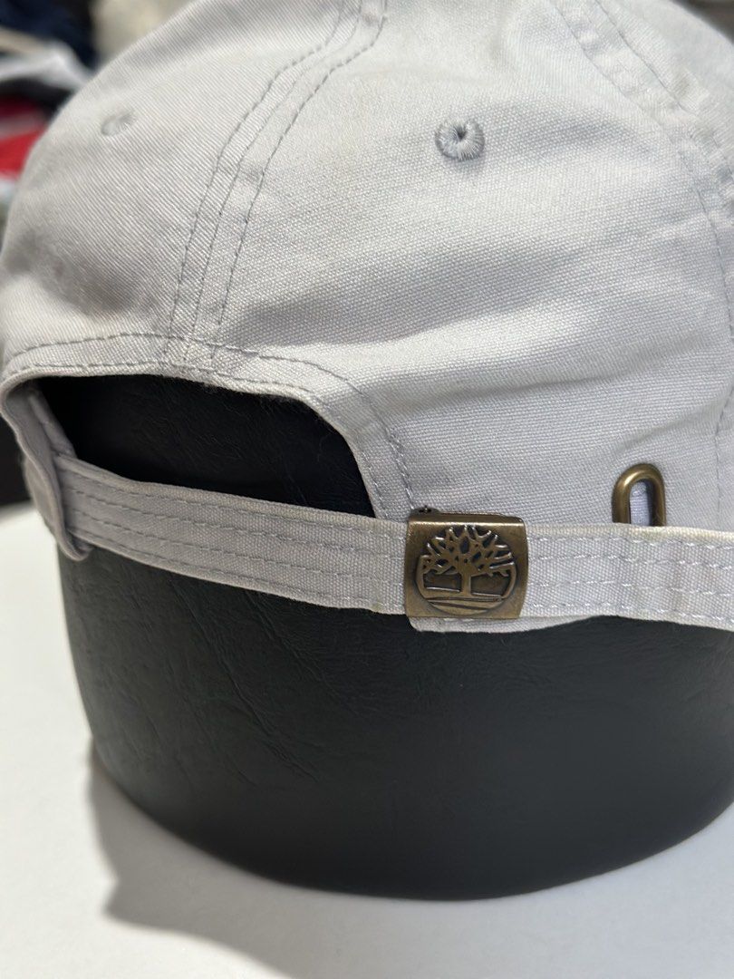 Timberland Soundview Cotton Canvas Baseball Cap Grey (Category: Caps & Hats) located in Daet. Submitted by thrifthings2018 (Listing ID 1469475813, Image 3). Description: - Brand: Timberland Soundview - Color: Grey - Material: 100% cotton canvas body (lining: 78% polyester, 22% cotton) - Design: Embroidered tree logo on the front - Closure: Adjustable strapback with metallic tree-logo buckle - Size: OS/TU (One Size) - Style Number: TB0A1E9M - Cond