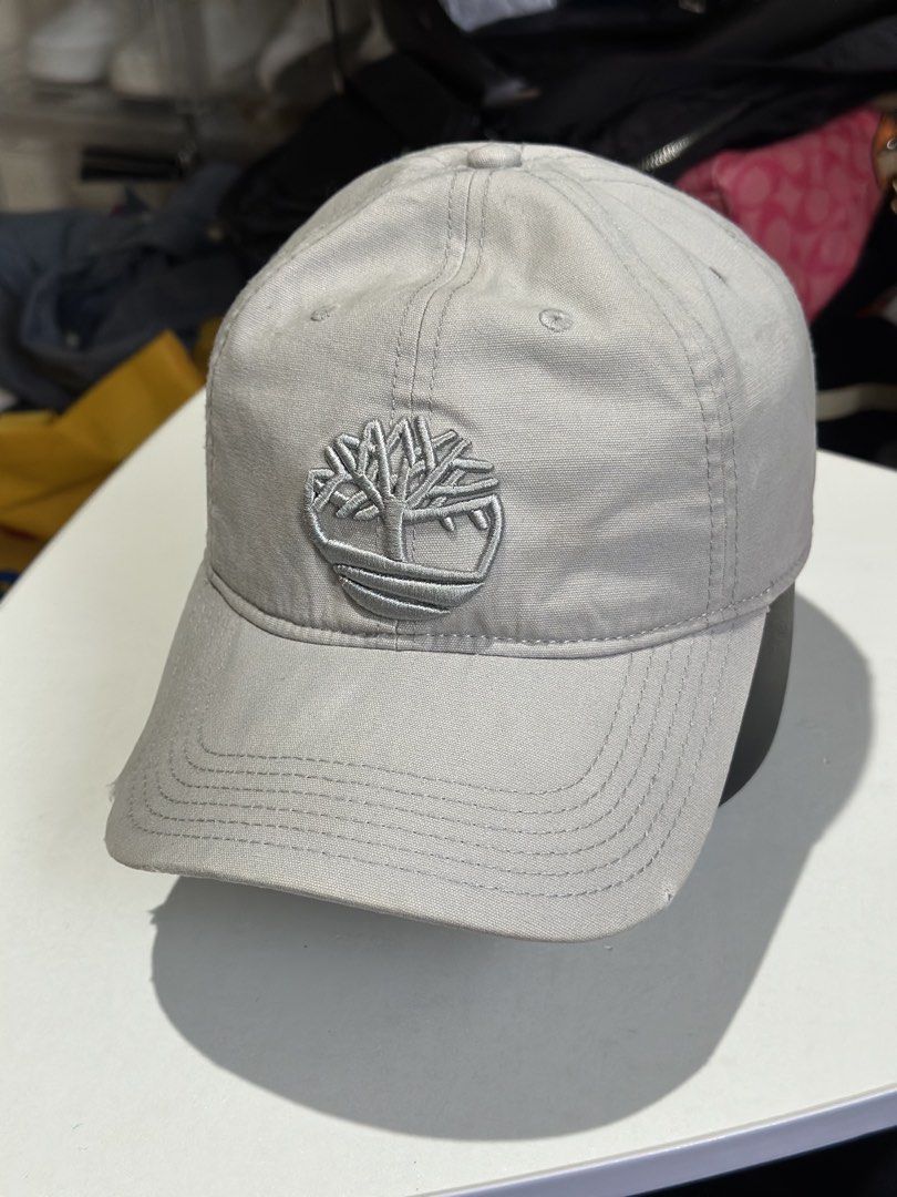 Timberland Soundview Cotton Canvas Baseball Cap Grey (Category: Caps & Hats) located in Daet. Submitted by thrifthings2018 (Listing ID 1469475813, Image 2). Description: - Brand: Timberland Soundview - Color: Grey - Material: 100% cotton canvas body (lining: 78% polyester, 22% cotton) - Design: Embroidered tree logo on the front - Closure: Adjustable strapback with metallic tree-logo buckle - Size: OS/TU (One Size) - Style Number: TB0A1E9M - Cond