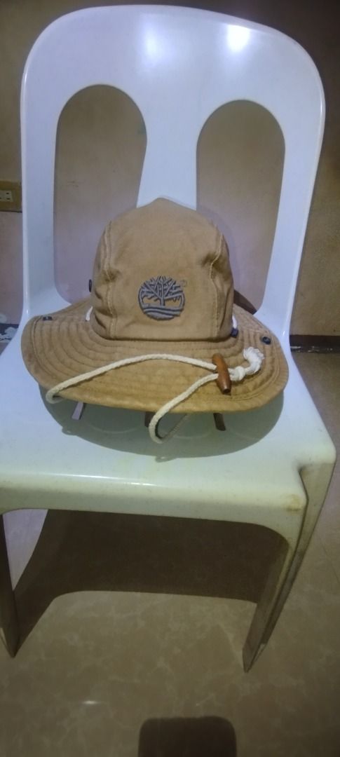 Timberland Tan Bucket Hat Sun Hat (Category: Caps & Hats) located in Caloocan City. Submitted by jrdar (Listing ID 1469496515, Image 1). Description: - Brand: Timberland - Color: Classic Tan - Material: Durable canvas - Logos: Embroidered tree logo on front, text logo on back - Features: Adjustable white chin cord with toggle and leather accents - Versatility: Snap buttons on the sides to wear the brim up - Condition: Excellent, well-maintained.