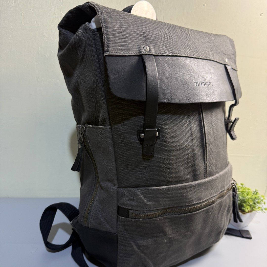 Timbuk2 Rogue Backpack Dark Grey Canvas Leather Flap (Category: Backpacks) located in Bago City. Submitted by g___shop (Listing ID 1469500347, Image 3). Description: - Brand/Model: Timbuk2 Rogue Backpack - Color/Material: Dark grey canvas with black leather flap - Storage: Main compartment with dual buckle closure, front zipper pocket, and side zip compartment - Comfort: Padded quilted shoulder straps - Condition: Excellent everyday bag with ampl