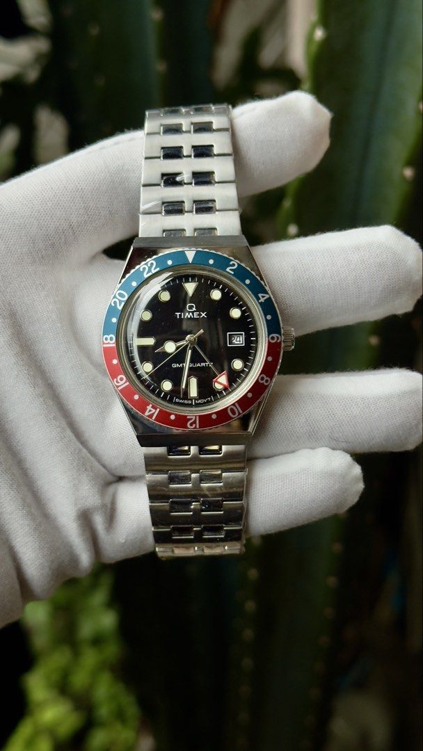 Timex Q GMT Pepsi Bezel Quartz Watch (Category: Men's Watches) located in Manila. Submitted by junjun12356 (Listing ID 1469521136, Image 2). Description: - Brand: Timex Q GMT Quartz Watch - Bezel: Iconic blue and red Pepsi bezel - Dial: Black dial with index markers and 3 o'clock date window - Condition: Brand new, stainless steel bracelet still wrapped in factory plastic film - Inclusions: Original store price tag attached (PHP 18,995.00) - Deta