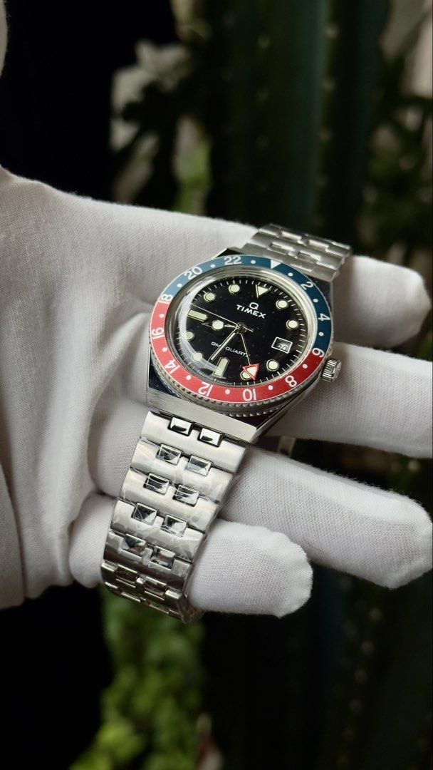 Timex Q GMT Pepsi Bezel Quartz Watch (Category: Men's Watches) located in Manila. Submitted by junjun12356 (Listing ID 1469521136, Image 3). Description: - Brand: Timex Q GMT Quartz Watch - Bezel: Iconic blue and red Pepsi bezel - Dial: Black dial with index markers and 3 o'clock date window - Condition: Brand new, stainless steel bracelet still wrapped in factory plastic film - Inclusions: Original store price tag attached (PHP 18,995.00) - Deta
