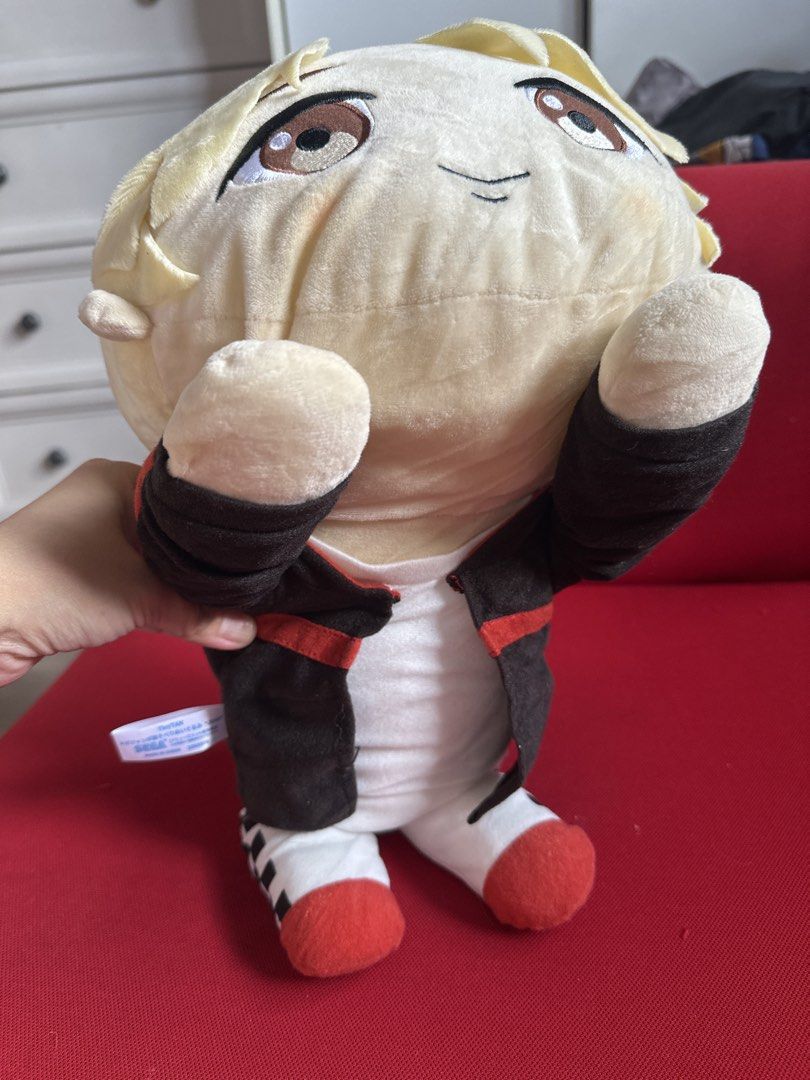 TinyTAN SEGA plush toy doll BTS (Category: Plushies & Soft Toys) located in Cainta. Submitted by shopbyyna (Listing ID 1469429297, Image 3). Description: - Official TinyTAN SEGA plush toy - Blonde hair style with detailed embroidered facial features - Wearing a stylish black jacket with red trim, white pants, and sneakers - Sitting posture style with soft, clean fabric - Original tag still attached on the side - Perfect collectible item for BTS A