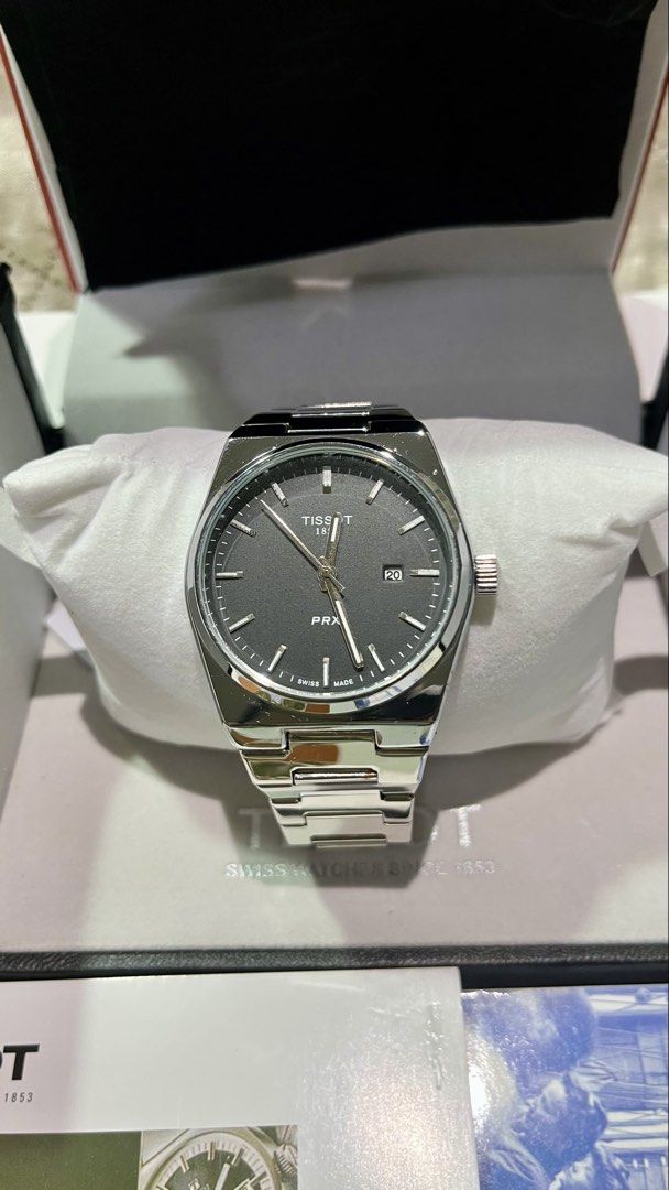Tissot PRX Quartz Watch with Original Boxe (Category: Luxury Watches) located in Cebu City. Submitted by jov_146 (Listing ID 1469572138, Image 2). Description: - Brand: Tissot PRX Quartz Watch - Material: Stainless steel with sapphire crystal glass - Clasp: Butterfly clasp with 1853 branding - Features: Water resistant - Inclusions: Original red and black Tissot presentation box and booklet RFS : decluttering for a friend.