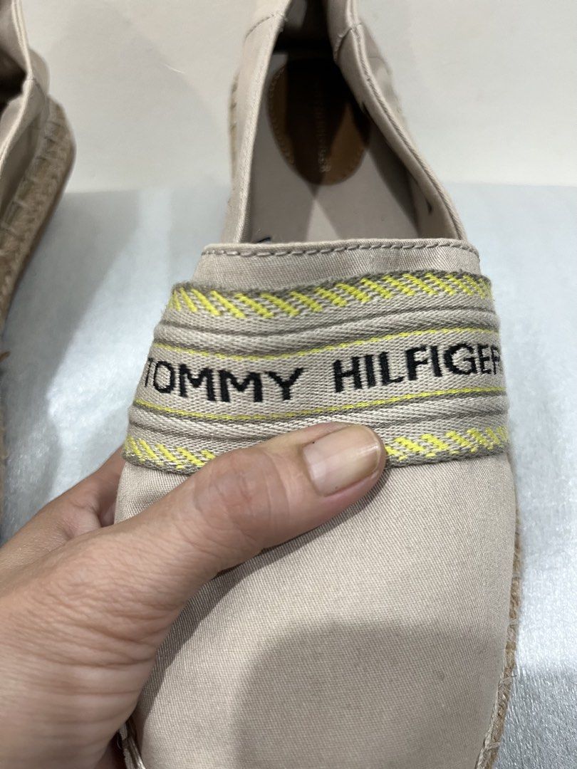 Tommy Hilfiger Beige Canvas Espadrilles Size US 9.5 (Category: Flats & Sandals) located in Talisay. Submitted by cherylu (Listing ID 1469570461, Image 3). Description: - Brand: Tommy Hilfiger - Style: Canvas slip-on espadrilles with woven jute detailing - Color: Beige with beige and yellow branded ribbon strap - Size: EUR 41 / UK 7 / US 9.5 / CM 26 - Features: Brown inner sole with embossed logo, textured rubber outsole with branding - Origin: Ma