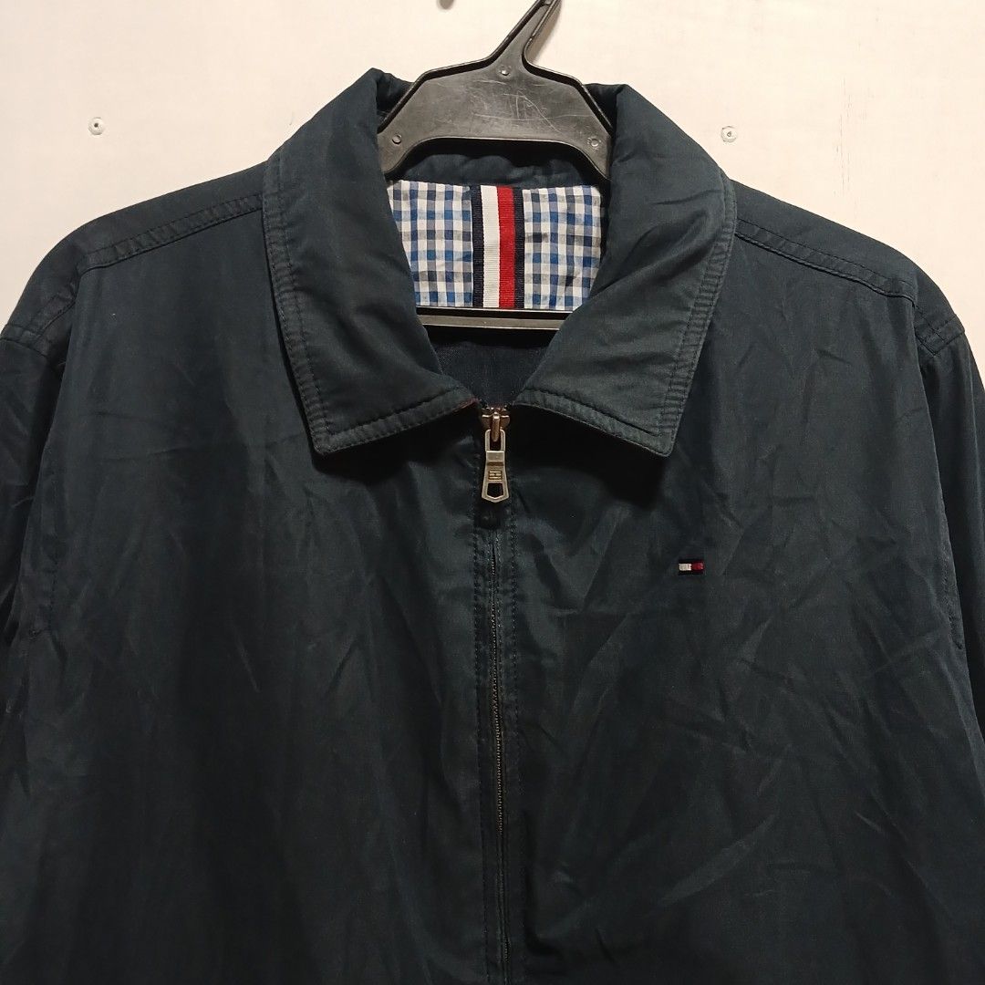 Tommy Hilfiger navy blue lightweight zip-up jacket (Category: Coats, Jackets and Outerwear) located in Manila. Submitted by joefrey12 (Listing ID 1469496194, Image 2). Description: - Brand: Tommy Hilfiger - Color: Navy Blue - Size: Medium (M) 22x27 - Condition: Excellent pre-loved / Good as new - Features: Classic collar, front zipper closure, embroidered chest logo - Interior: Stylish blue and white checkered lining with signature red, white, an