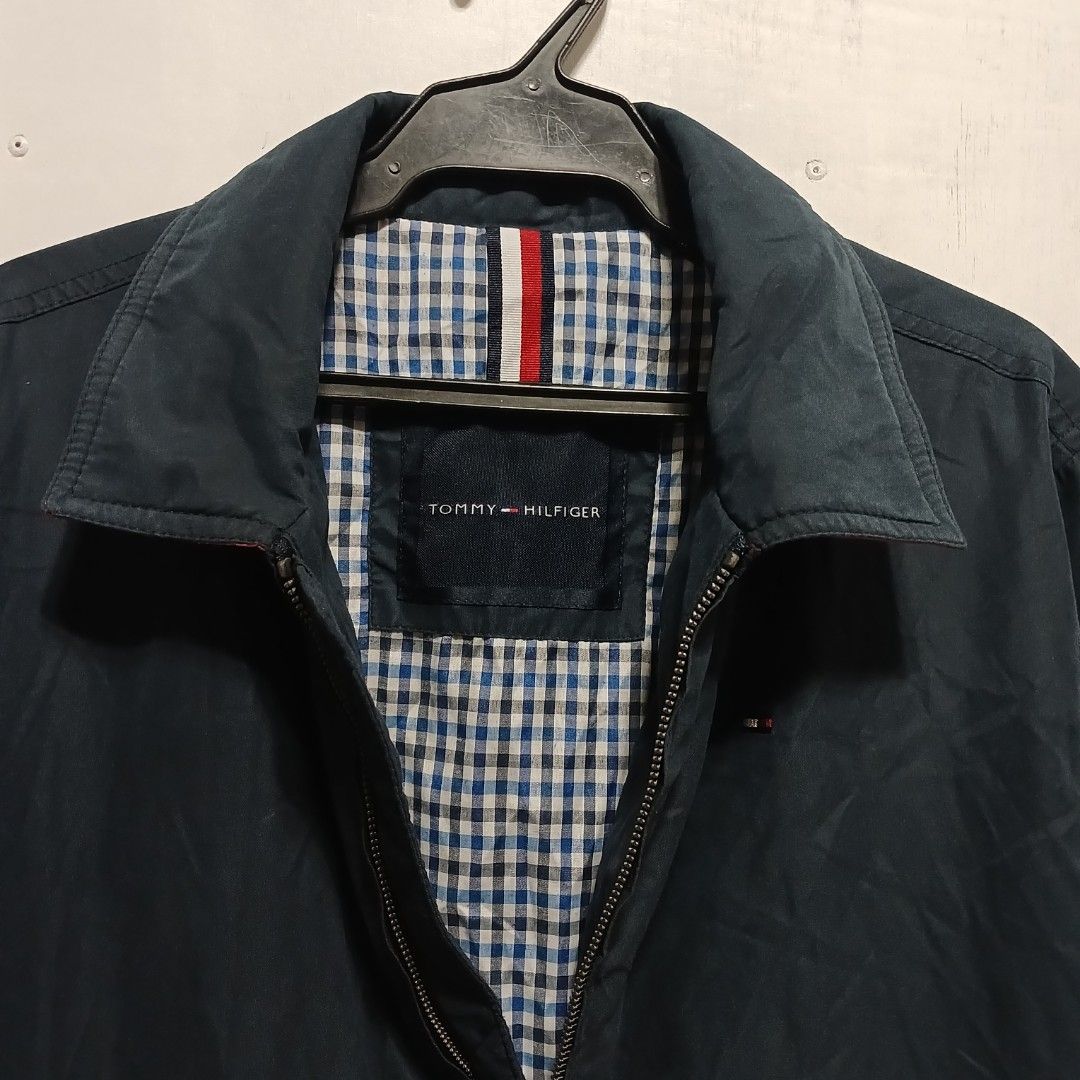 Tommy Hilfiger navy blue lightweight zip-up jacket (Category: Coats, Jackets and Outerwear) located in Manila. Submitted by joefrey12 (Listing ID 1469496194, Image 3). Description: - Brand: Tommy Hilfiger - Color: Navy Blue - Size: Medium (M) 22x27 - Condition: Excellent pre-loved / Good as new - Features: Classic collar, front zipper closure, embroidered chest logo - Interior: Stylish blue and white checkered lining with signature red, white, an