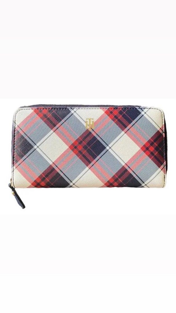 Tommy Hilfiger Plaid Zip Around Wallet (Category: Wallets & Card holders) located in Quezon City. Submitted by leilumiereclassique (Listing ID 1469412520, Image 1). Description: - Brand: Tommy Hilfiger - Design: Classic red, navy, and white plaid pattern with dark navy trim - Material/Finish: Durable Saffiano texture - Hardware: Gold-tone hardware with engraved Tommy Hilfiger lettering on the zipper pull - Closure: Secure zip-around design - Deta