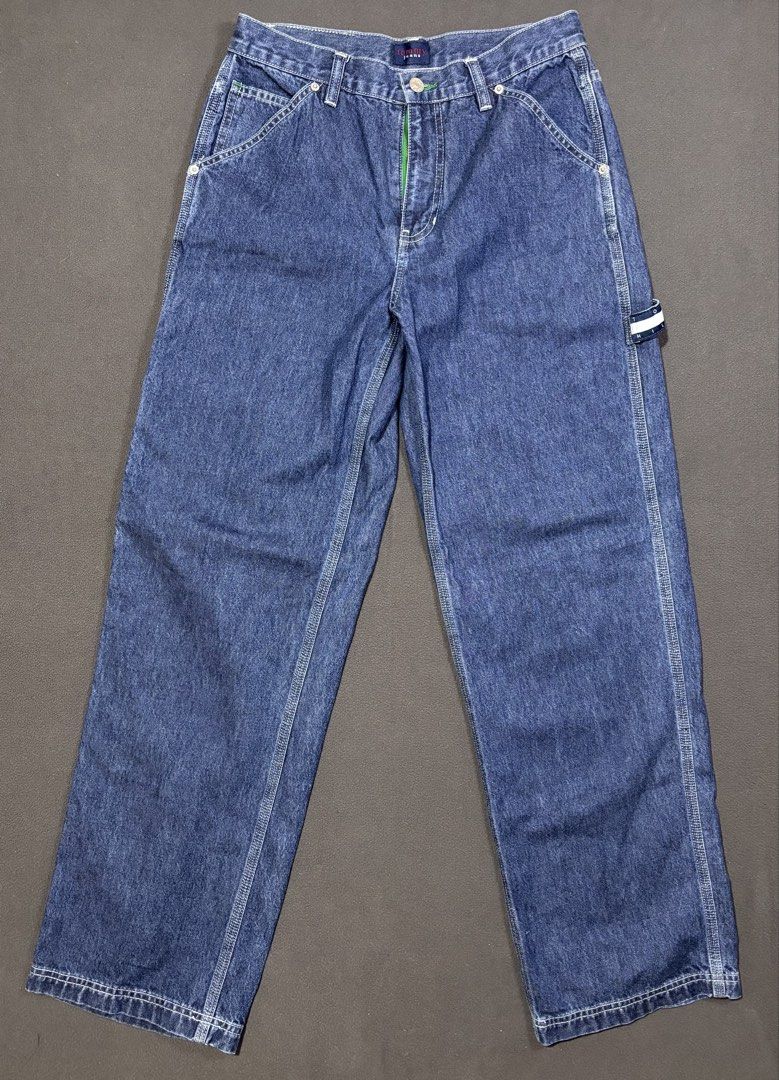 Tommy Jeans Carpenter Denim Pants Size 31 (Category: Jeans) located in Mabalacat. Submitted by _limitlessfashion (Listing ID 1469423105, Image 1). Description: - Brand: Tommy Jeans - Style: Denim carpenter pants with classic blue wash - Size 31 - Length 41 - Hem 9.5 - No issue, in good condition - Fit: Relaxed fit with button fly closure - Details: Utility pockets, side hammer loop, and contrast white stitching - Branding: Iconic Tommy Hilfiger f