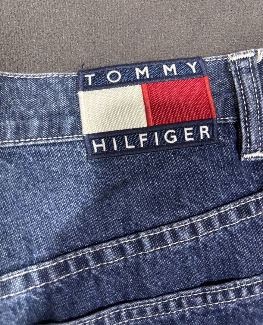 Tommy Jeans Carpenter Denim Pants Size 31 (Category: Jeans) located in Mabalacat. Submitted by _limitlessfashion (Listing ID 1469423105, Image 3). Description: - Brand: Tommy Jeans - Style: Denim carpenter pants with classic blue wash - Size 31 - Length 41 - Hem 9.5 - No issue, in good condition - Fit: Relaxed fit with button fly closure - Details: Utility pockets, side hammer loop, and contrast white stitching - Branding: Iconic Tommy Hilfiger f