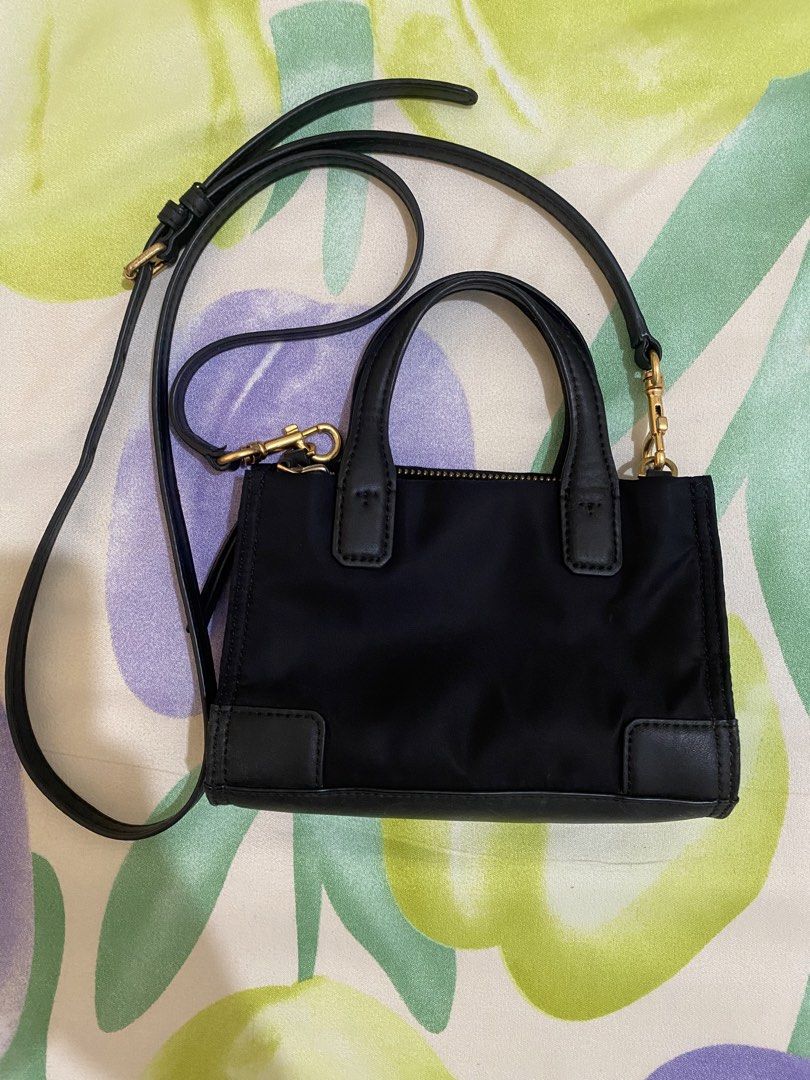 Tory Burch Black Mini Tote Crossbody Bag (Category: Luxury Bags & Wallets) located in Paranaque City. Submitted by chelleann12 (Listing ID 1469445534, Image 2). Description: - Brand: Tory Burch - Material: Durable black nylon with chic leather trim - Logo: Iconic big embossed T logo on the front - Hardware: Premium gold-tone hardware - Straps: Dual top handles plus a detachable, adjustable crossbody strap - Closure: Secure top zip closure - Size: