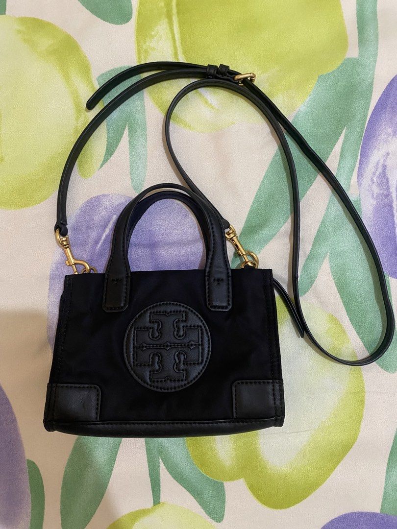Tory Burch Black Mini Tote Crossbody Bag (Category: Luxury Bags & Wallets) located in Paranaque City. Submitted by chelleann12 (Listing ID 1469445534, Image 1). Description: - Brand: Tory Burch - Material: Durable black nylon with chic leather trim - Logo: Iconic big embossed T logo on the front - Hardware: Premium gold-tone hardware - Straps: Dual top handles plus a detachable, adjustable crossbody strap - Closure: Secure top zip closure - Size: