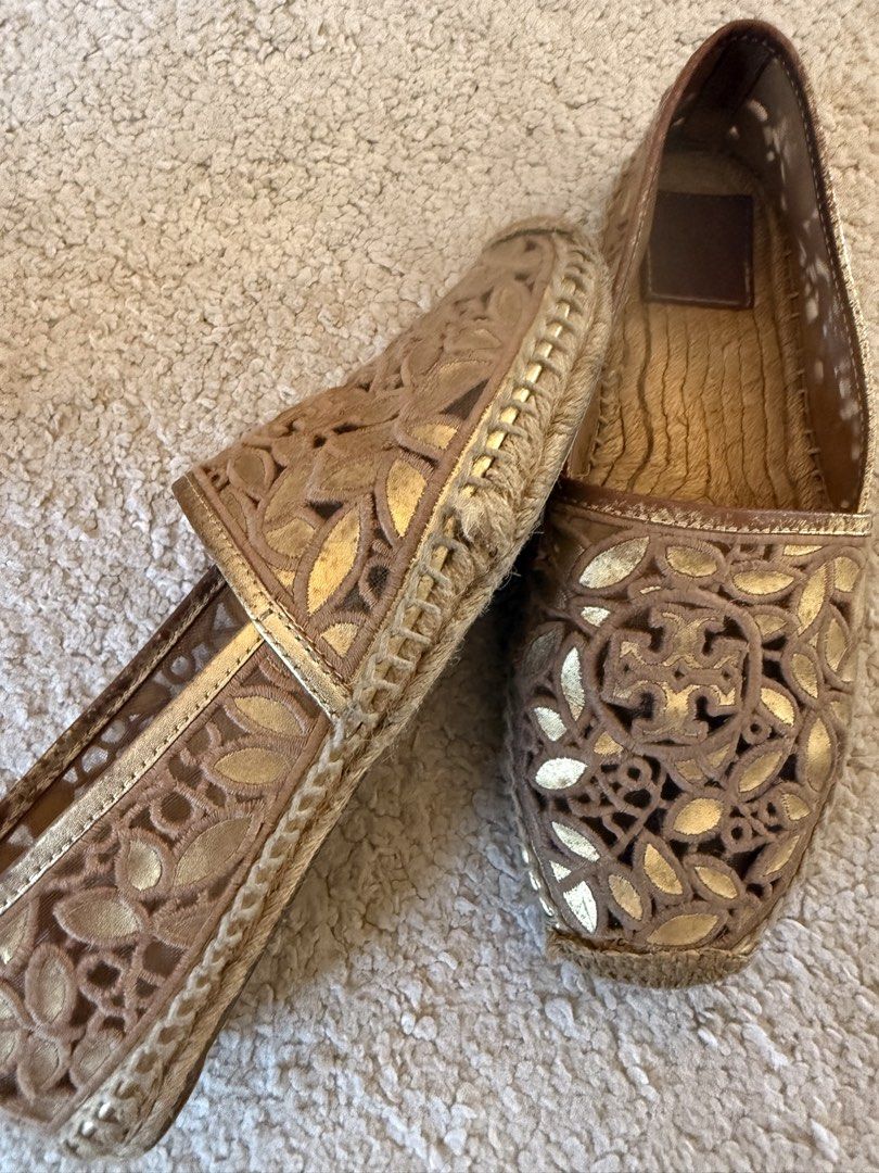 Tory Burch Gold Cutout Espadrilles Flats (Category: Flats & Sandals) located in Muntinlupa City. Submitted by pattti_gv (Listing ID 1469453666, Image 3). Description: - Brand: Tory Burch - Style: Slip-on espadrille flats - Color/Design: Gold with chic cutout pattern - Materials: Leather insoles with embossed logo, classic jute-wrapped soles - Condition: Regular signs of wear on soles and footbeds - Ideal for: Warm weather, casual chic outfits, an