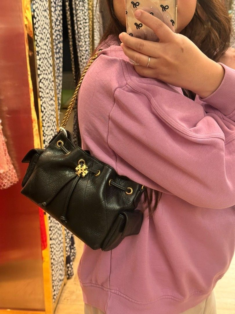 Tory Burch Mini Charlie Bucket Bag (Category: Shoulder Bags) located in Las Pinas. Submitted by shopwithmira13 (Listing ID 1469519119, Image 3). Description: - Brand: Tory Burch - Material: Premium black pebbled leather with chic quilted pattern - Hardware: Gold-tone accents and signature logo - Closure: Secure drawstring closure - Pockets: Convenient side pockets with flaps - Strap: Convertible leather and gold chain (wear as shoulder bag or cro