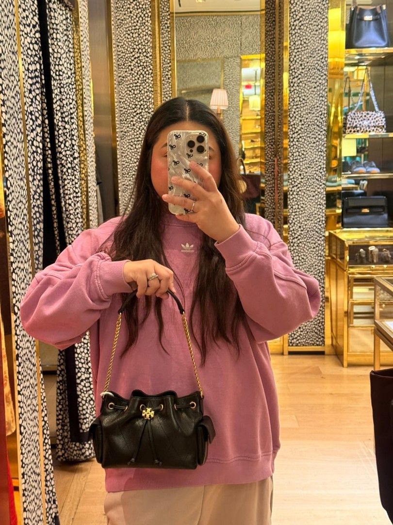 Tory Burch Mini Charlie Bucket Bag (Category: Shoulder Bags) located in Las Pinas. Submitted by shopwithmira13 (Listing ID 1469519119, Image 2). Description: - Brand: Tory Burch - Material: Premium black pebbled leather with chic quilted pattern - Hardware: Gold-tone accents and signature logo - Closure: Secure drawstring closure - Pockets: Convenient side pockets with flaps - Strap: Convertible leather and gold chain (wear as shoulder bag or cro