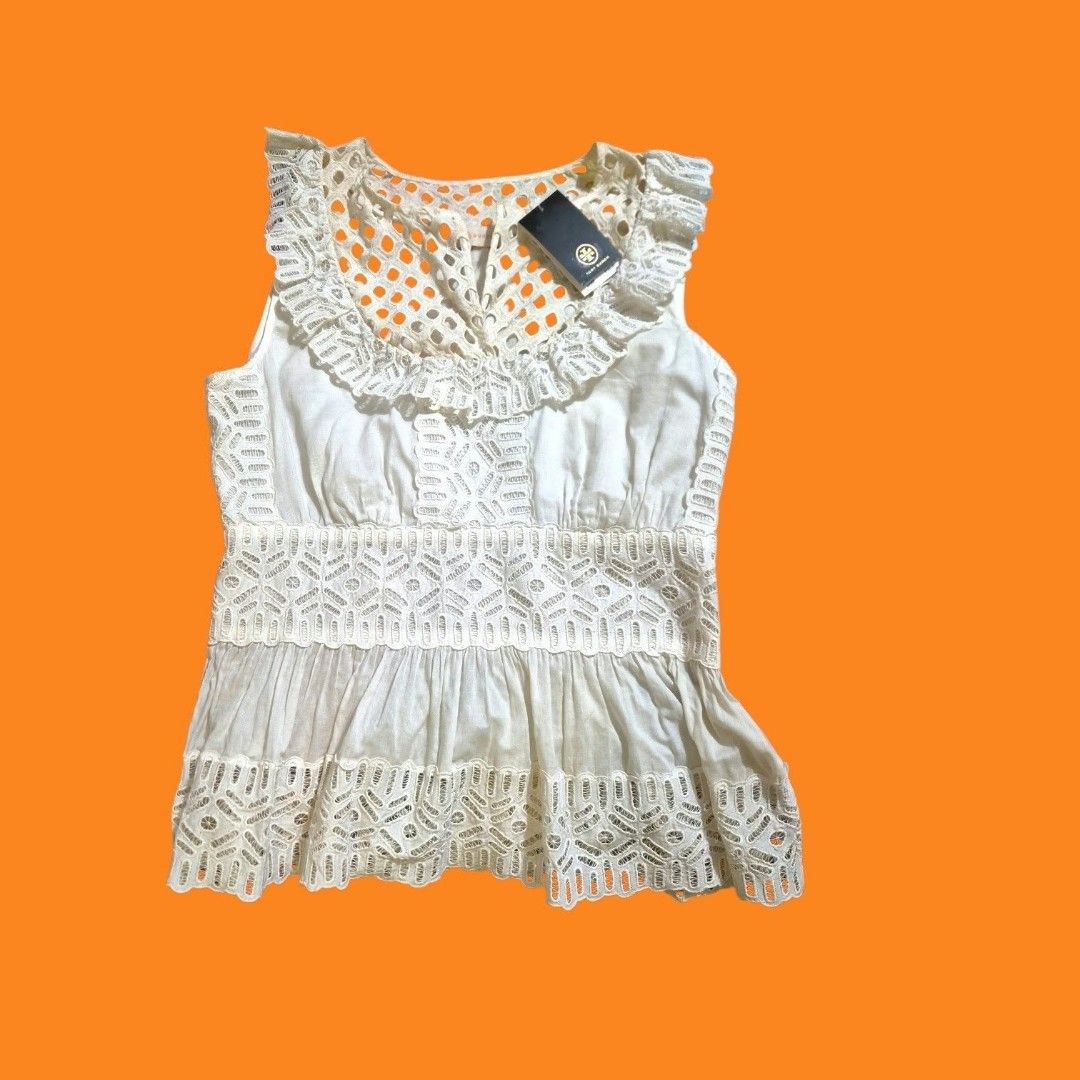 Tory Burch Off White Hermosa Top Size 10 (Category: Blouses) located in Paranaque City. Submitted by calm_youngstore7 (Listing ID 1469463995, Image 2). Description: -LAST PIECE SAKE ! 80% OFF RETAIL! Brand: Tory Burch - Style: Hermosa Top - Color: Off-White - Size: 10 - Condition: Brand new with original tags attached - Retail Price: €180 - Details: Eyelet lace yoke, ruffle collar, sleeveless, flared peplum hem with cutout details - Ideal for: Su
