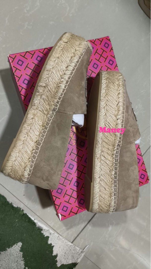Tory Burch Taupe Espadrille Flats (Category: Flats & Sandals) located in Ozamiz City. Submitted by Maney8 (Listing ID 1469412062, Image 2). Description: - Brand: Tory Burch - Style: Taupe suede espadrille flats with slip-on design - Features: Braided jute soles and large embossed logo on top - Inclusions: Original pink patterned shoebox and matching paper bag - Condition: Excellent, guaranteed authentic - Perfect for: Casual outings, weekend styl