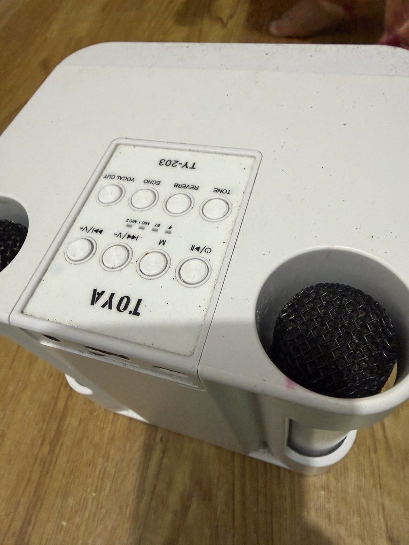 TOYA TY-203 Karaoke Machine with Microphones (Category: Soundbars, Speakers & Amplifiers) located in Manila. Submitted by zenwind.6c4965 (Listing ID 1469483734, Image 1). Description: - Model: TOYA TY-203 Portable Karaoke System (White) - Includes 2 black mesh microphones with built-in side holders - Top panel controls for tone, reverb, echo, vocal cut, track skipping, and mode switching - Wireless Bluetooth connectivity - Rechargeable battery-po