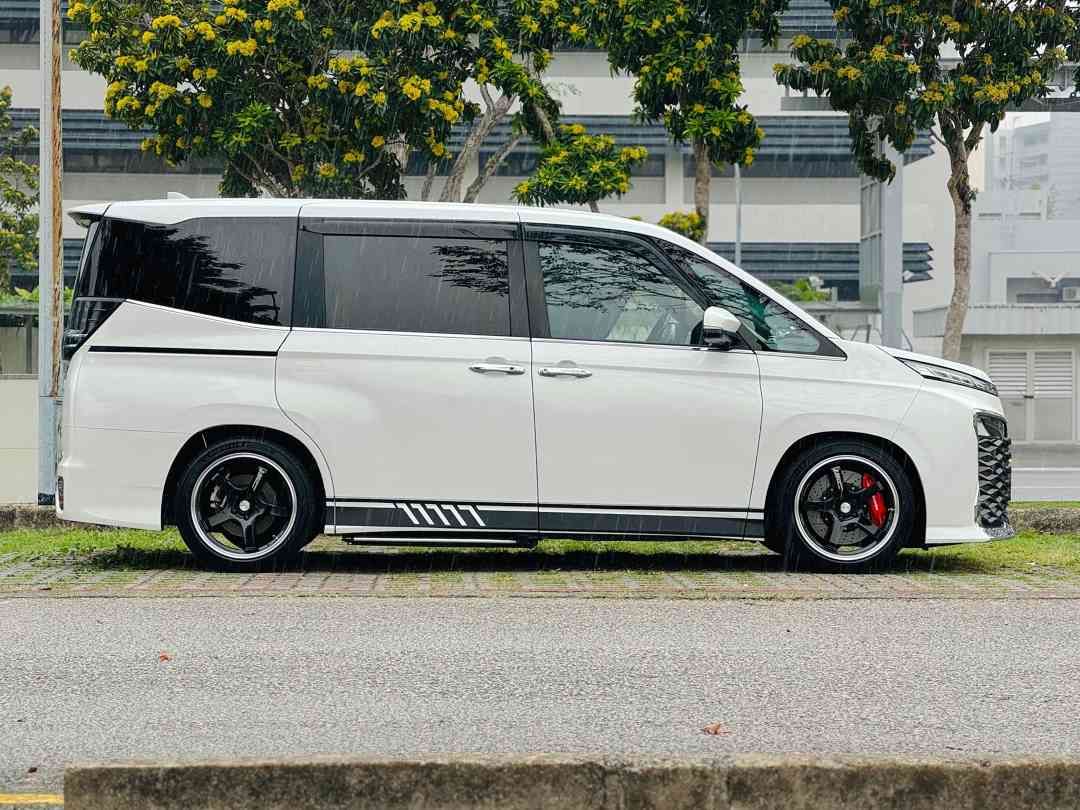 Toyota Voxy Hybrid 1.8 SZ 7-Seater (A) (Category: Used Cars) located in Singapore. Submitted by carbuyersclub (Listing ID 1469444884, Image 2). Description: CarBuyers Club 500+ Google Reviews | SGCM Premium Dealer 2026! If you're in the market for an efficient, spacious yet comfortable MPV for every passenger, look no further! High spec SZ! Low genuine mileage used, registered for PHV but not used. Useful quality of life mods including auto tailg