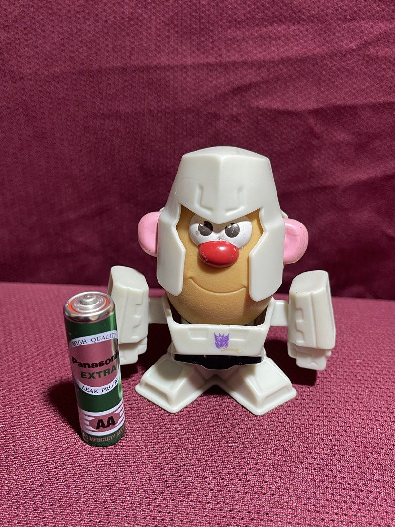 Transformers Mr. Potato Head Megatron McDonald's Toy (Category: Figurines & Statues) located in Manila. Submitted by dstrangerthings (Listing ID 1469543744, Image 2). Description: - Item: McDonald's Transformers Mr. Potato Head - Megatron - Release Year: 2022 by Hasbro - Size: Slightly taller than a standard AA battery - Features: Detachable helmet, body, and potato piece for easy disassembling - Condition: Great, fun mashup collectible for fans.