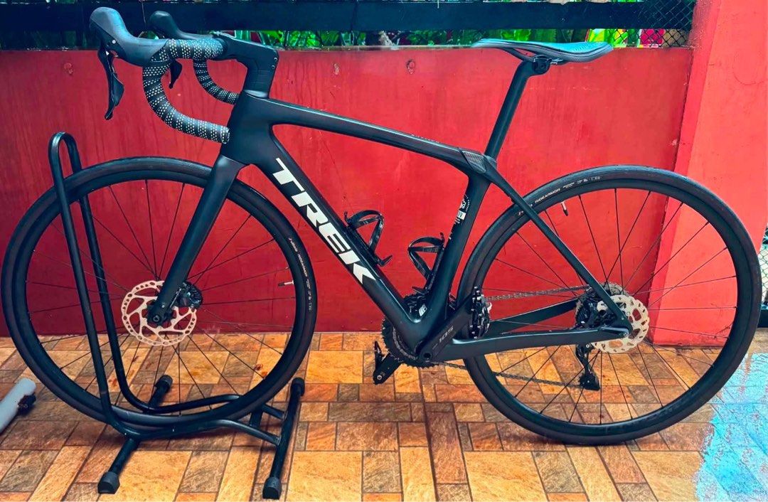 Trek Domane SL 5 Gen 4 size 52cm (Category: Bicycles) located in Bacoor. Submitted by luvtoshoppe (Listing ID 1469435180, Image 1). Description: - Model: Trek Domane SL 5 Gen 4 road bike in matte black - Size: 52cm endurance geometry carbon frame with IsoSpeed decoupler - Groupset: Shimano 105 with hydraulic disc brakes - Italia saddle included - Extras: Patterned black and white handlebar tape - Condition: Clean frame, meticulously well-maintain