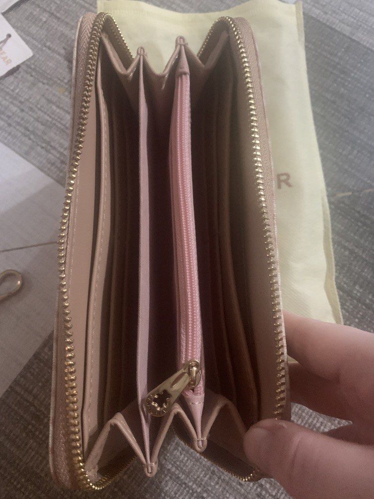 TTWN & BEAR Pink Houndstooth Long Zip Wallet (Category: Wallets & Card holders) located in Bocaue. Submitted by bajiborgy08 (Listing ID 1469522773, Image 3). Description: - Brand: TTWN & BEAR - Design: Pink houndstooth pattern with cute teddy bear graphic - Hardware: Gold-tone with bear-shaped zipper pulls - Interior: Multiple card slots, cash compartments, and zippered coin pocket - Inclusions: Matching wrist strap, original tags, and dust bag -