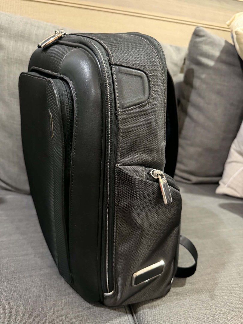 TUMI Black Business Laptop Backpack (Category: Backpacks) located in Manila. Submitted by mialuna_ (Listing ID 1469422120, Image 2). Description: - Authentic black TUMI backpack made from durable nylon with stylish leather trim - Multiple exterior and interior zippered compartments for easy daily organization - Built-in key leash and metal TUMI Tracer plate for security - Comfortable padded shoulder straps and sturdy top handle - Sleek dark blue 