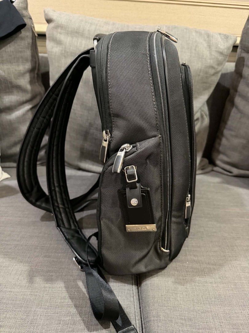 TUMI Black Business Laptop Backpack (Category: Backpacks) located in Manila. Submitted by mialuna_ (Listing ID 1469422120, Image 3). Description: - Authentic black TUMI backpack made from durable nylon with stylish leather trim - Multiple exterior and interior zippered compartments for easy daily organization - Built-in key leash and metal TUMI Tracer plate for security - Comfortable padded shoulder straps and sturdy top handle - Sleek dark blue 