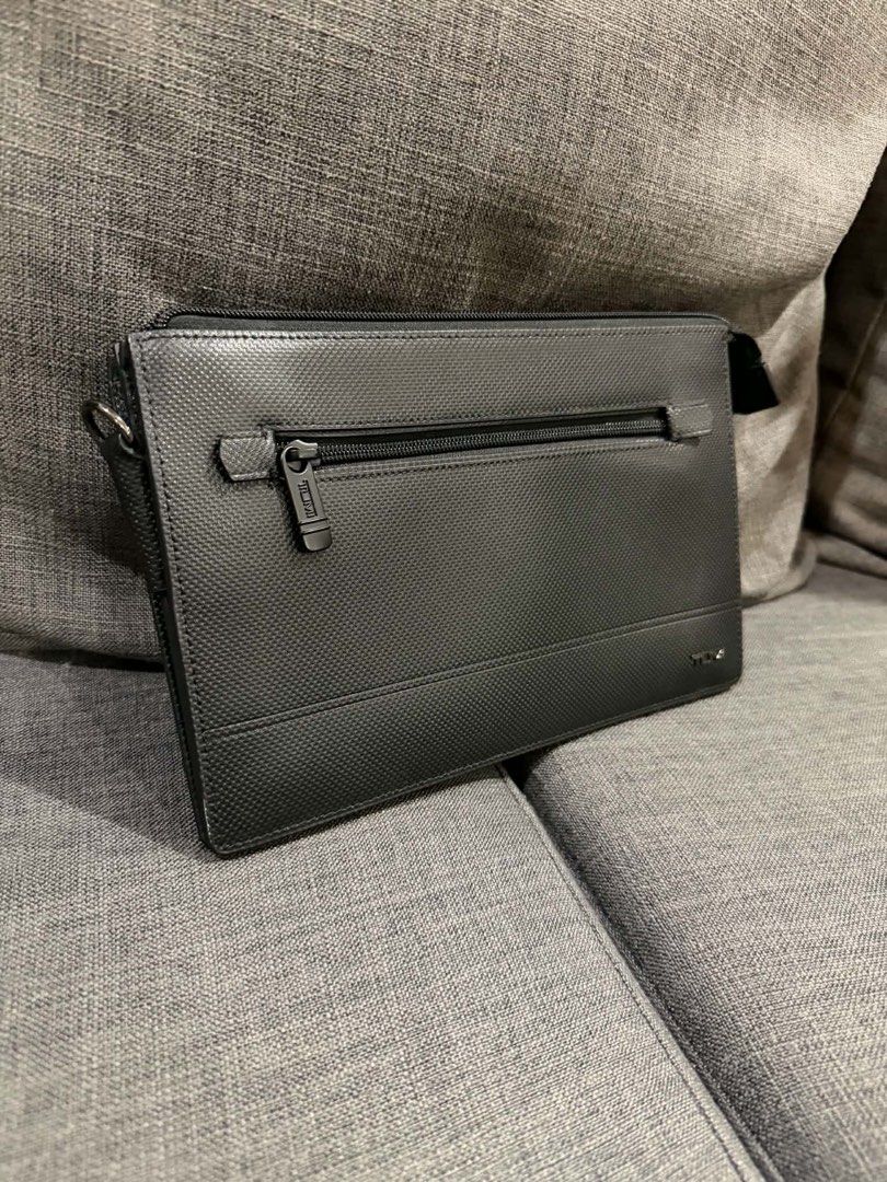 TUMI Black Patterned Organizer Clutch Bag (Category: Luxury Bags & Wallets) located in Manila. Submitted by mialuna_ (Listing ID 1469422494, Image 1). Description: Tumi black textured clutch, very clean exterior. Multiple zipped compartments inside for cards and small items. Front exterior zip pocket with Tumi branded pull. Durable material, professional look. Zips glide smoothly..
