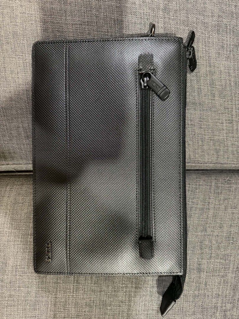 TUMI Black Patterned Organizer Clutch Bag (Category: Luxury Bags & Wallets) located in Manila. Submitted by mialuna_ (Listing ID 1469422494, Image 2). Description: Tumi black textured clutch, very clean exterior. Multiple zipped compartments inside for cards and small items. Front exterior zip pocket with Tumi branded pull. Durable material, professional look. Zips glide smoothly..