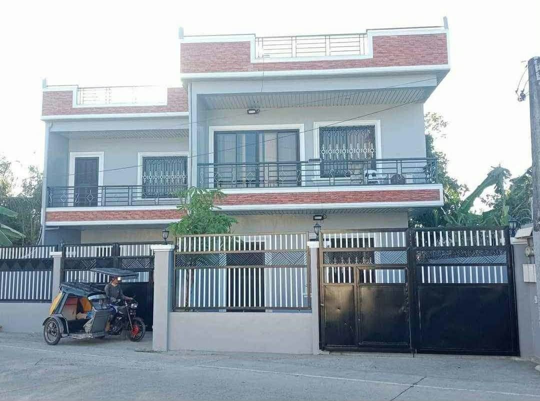 Two Storey Duplex House with Balcony and Gate (Category: House & Lot) located in Manila. Submitted by srcitizen23 (Listing ID 1469488159, Image 1). Description: - Two-storey modern house with a chic grey and red brick exterior finish - Features large glass sliding windows and a metal balcony on the second floor - Rooftop deck with safety railings included - Bright and airy interiors with plenty of natural light - Secure perimeter wall equipped wi