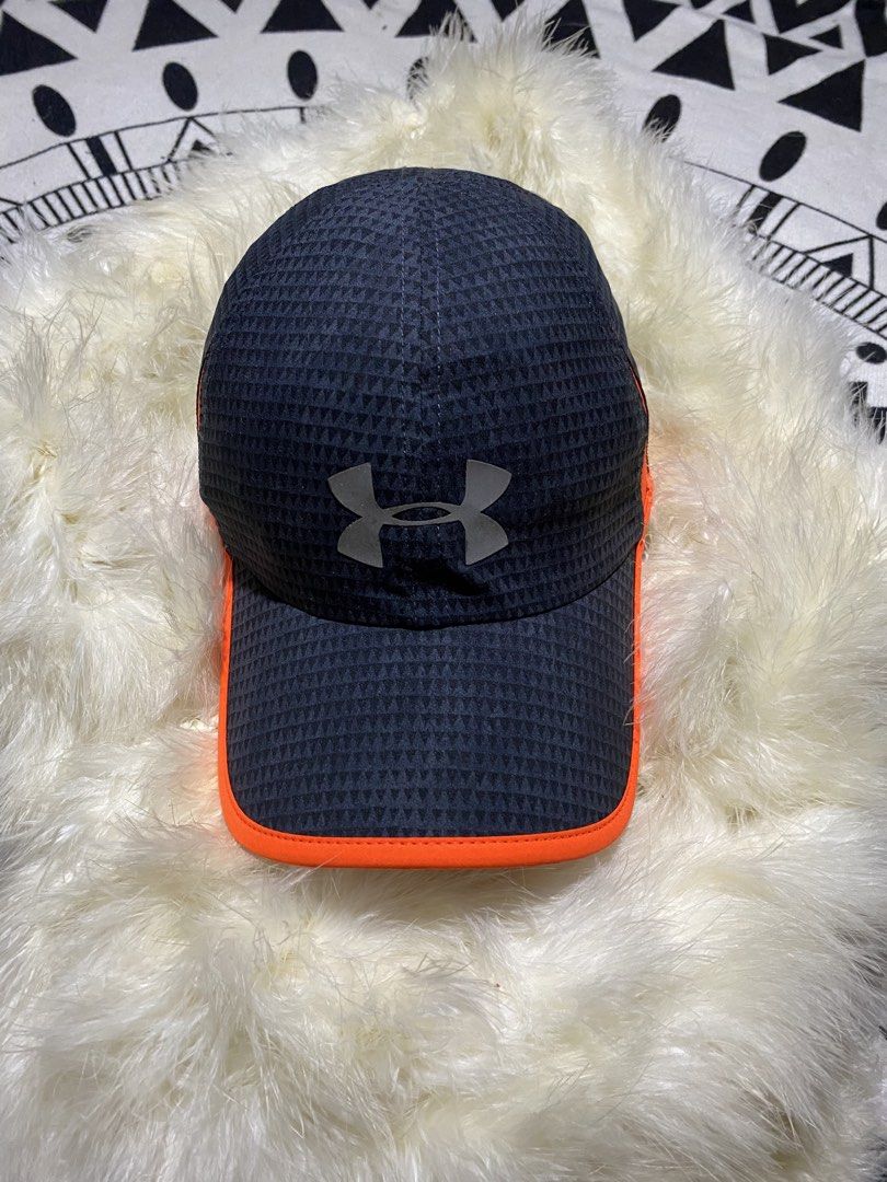 Under Armour Cap Black Orange (Category: Caps & Hats) located in Badiangan. Submitted by iralorana.thrift (Listing ID 1469419035, Image 2). Description: - Authentic Under Armour black cap with a stylish triangular pattern - High-visibility bright orange trim along the brim and side panels - Reflective silver UA logo on the front for low-light safety - Adjustable back strap featuring Under Armour lettering - Lightweight, breathable athletic materi