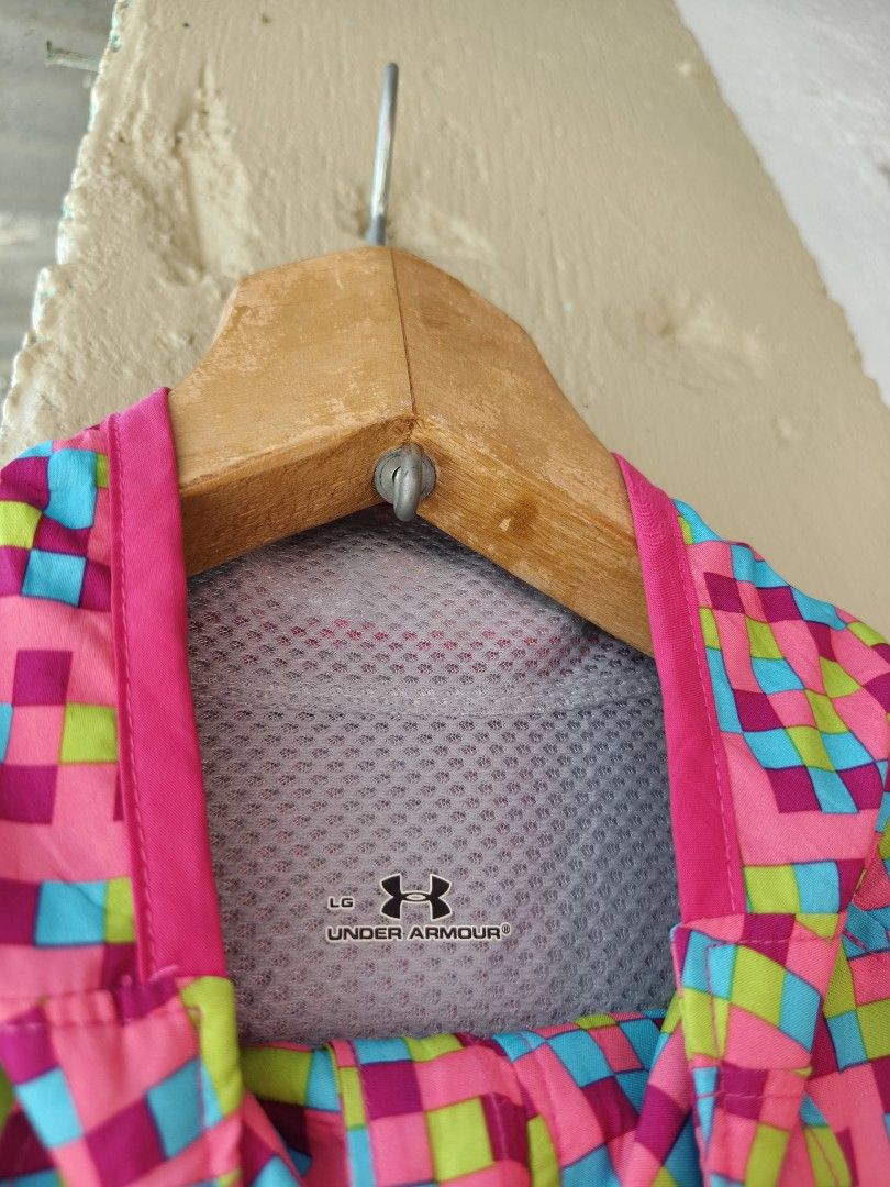 Under Armour Pixel Print Running Vest Size L (Category: Activewear) located in Binan City. Submitted by makinpeso0622 (Listing ID 1469439661, Image 3). Description: - Brand: Under Armour - Type: Running Vest - Design: Bright multi-color pixel pattern (pink, blue, and green) - Features: Full zip front, mock neck, breathable mesh lining, and small zippered chest pocket - Safety: Reflective tab on the back with UA Run branding - Size: Large - Origin