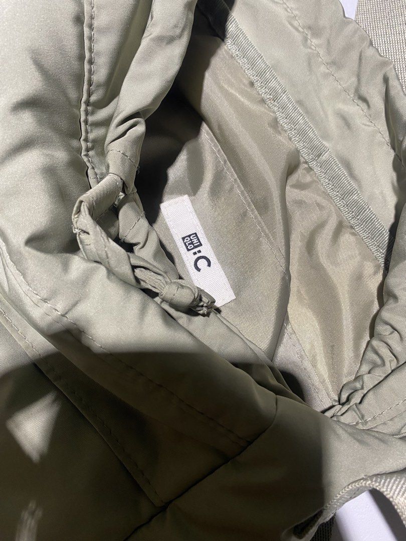 UNIQLO : C Green Drawstring Shoulder Bag (Category: Shoulder Bags) located in Manila. Submitted by fits_drip (Listing ID 1469560555, Image 2). Description: - Brand/Model: UNIQLO: C Drawstring Shoulder Bag - Color: Olive Green - Material: 100% Polyester (Shell, filling, lining, and strap) - Features: Adjustable shoulder strap, front exterior pocket, and secure drawstring main compartment - Origin: Made in China - Condition: Brand new / Excellent q