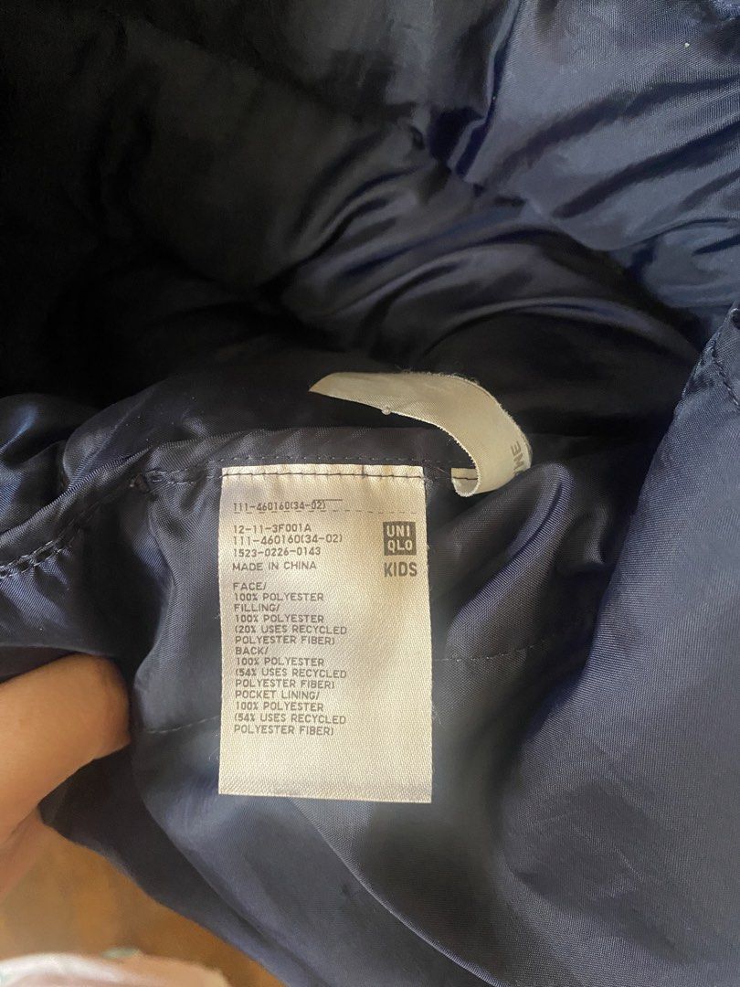 Uniqlo Kids Navy Puffer Jacket (Category: Babies & Kids Fashion) located in Baguio. Submitted by heath2600 (Listing ID 1469541520, Image 2). Description: - Brand: Uniqlo Kids - Color: Classic navy blue (easy to match with any outfit) - Style: Zip-up puffer jacket with high collar neck for extra warmth - Material: 100% polyester shell with eco-friendly recycled polyester filling - Condition: Clean interior tag, well-maintained - Perfect for cold w