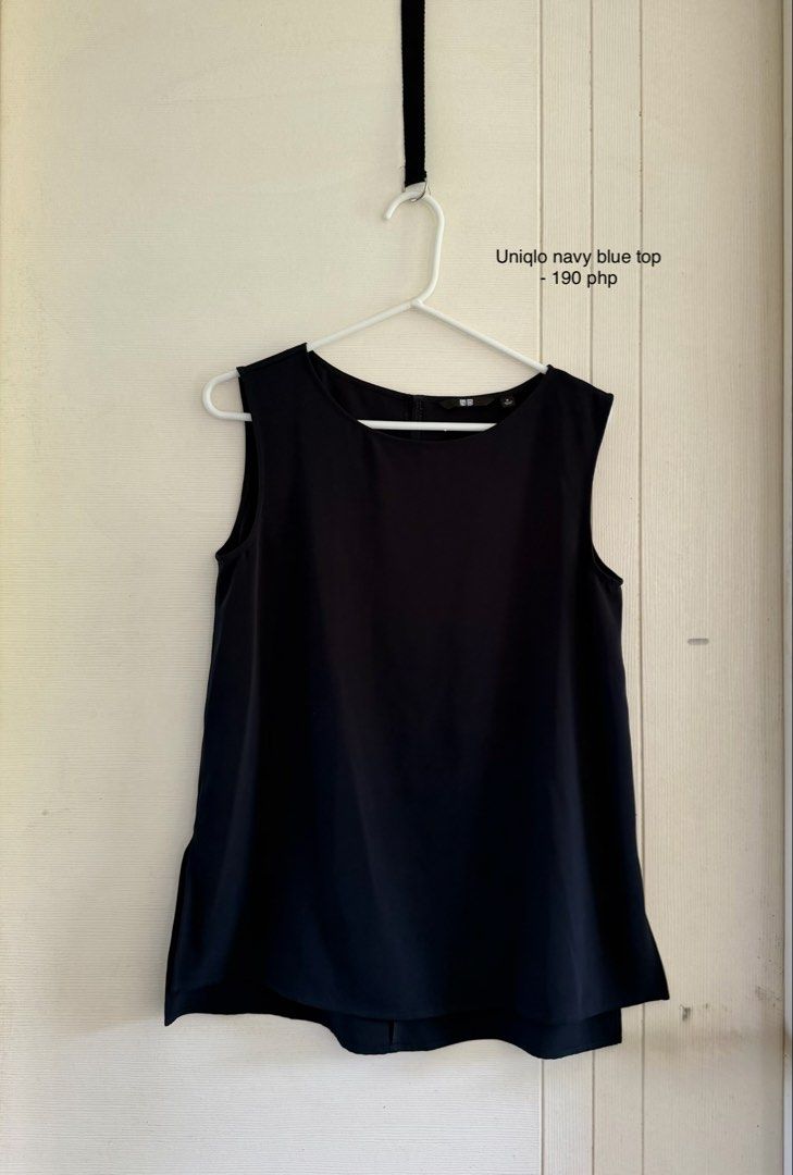 Uniqlo Navy Blue Top (Category: Sleeveless) located in Manila. Submitted by cinnmoroll (Listing ID 1469402411, Image 1). Description: - Brand: Uniqlo - Size: Medium - Color: Navy blue (solid dark blue) - Style: Sleeveless top with a scoop neckline - Material: Smooth, comfortable fabric - Condition: Excellent, with clean neckline label and tag intact - Versatility: Easy to pair with pants or skirts.